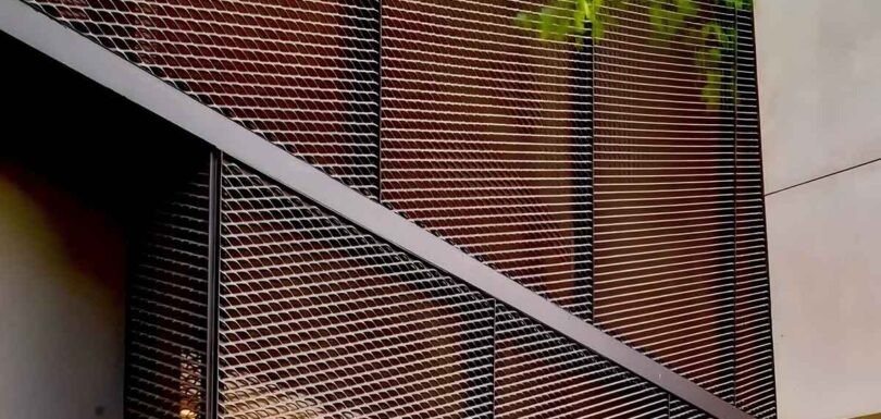 Architectural metal mesh facade supporting eco-friendly building design with modern patterns and sustainable features