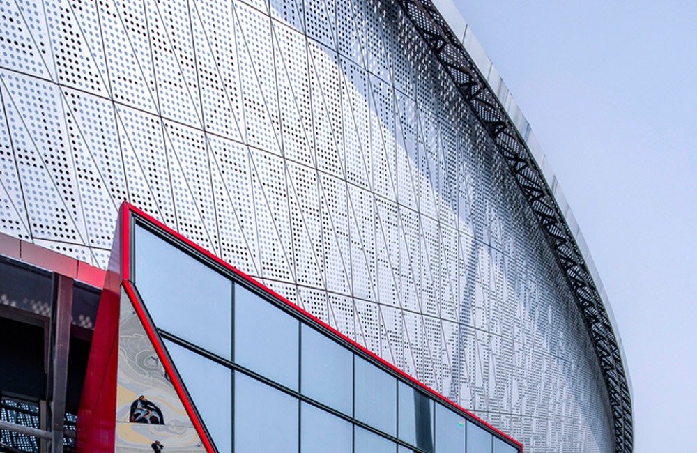 Contemporary perforated metal facade of the renovated Chongqing sports venue