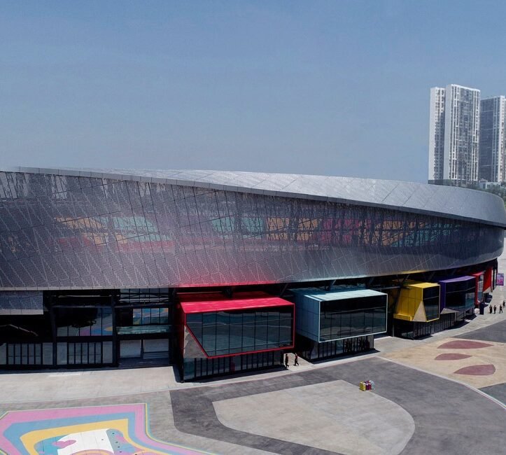 Perforated metal facade panels on the renovated Chongqing sports venue