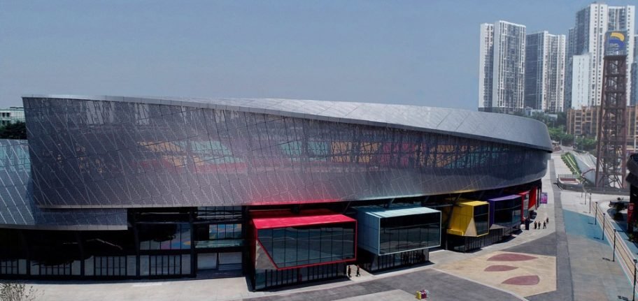Perforated metal facade panels on the renovated Chongqing sports venue