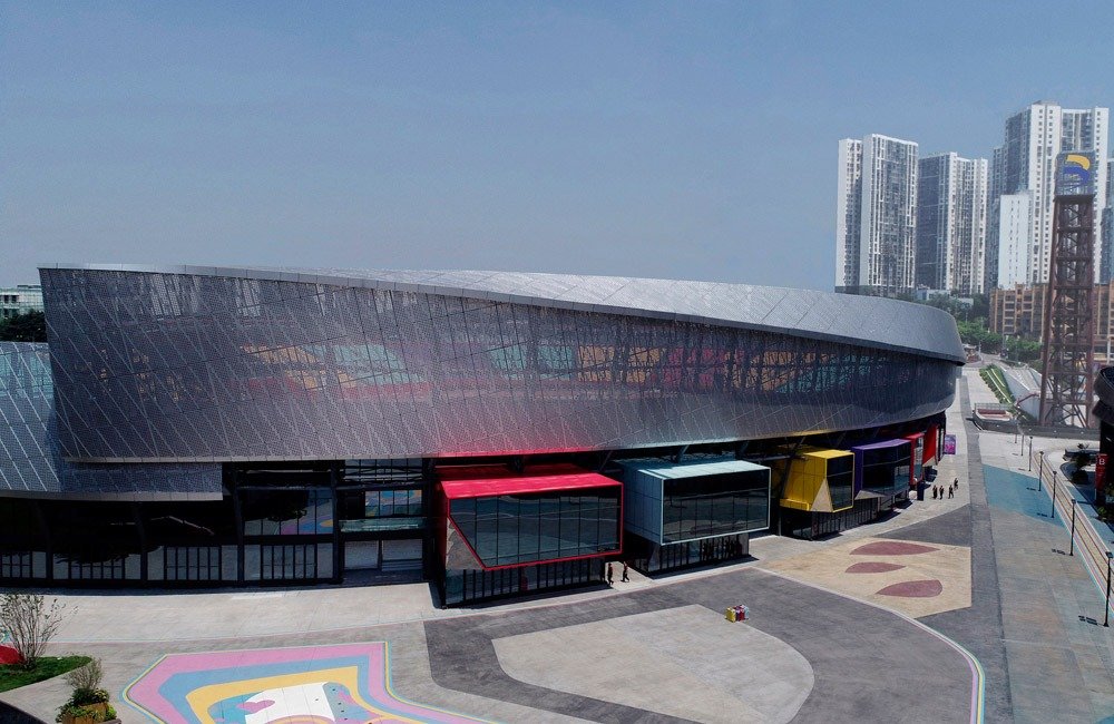 Perforated metal facade panels on the renovated Chongqing sports venue