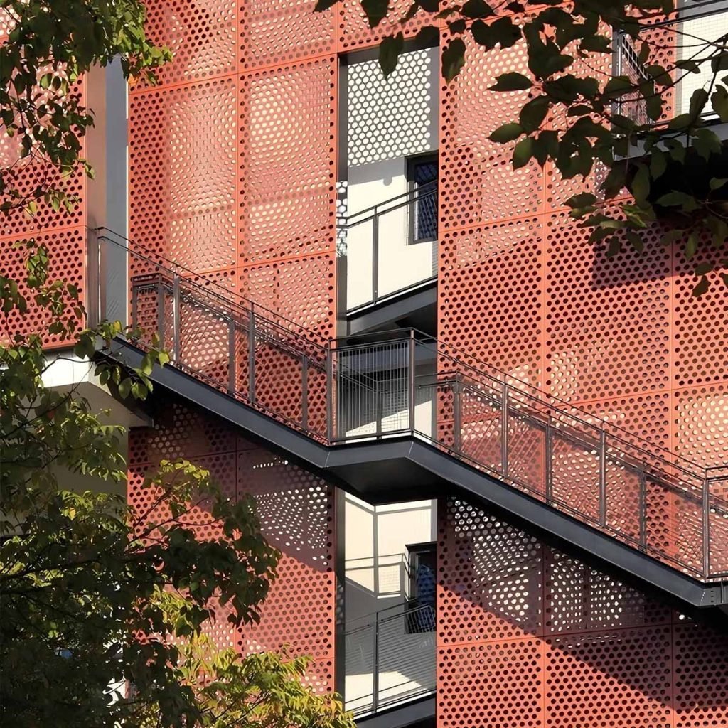 Architectural metal facade cladding system with custom panels for modern building design