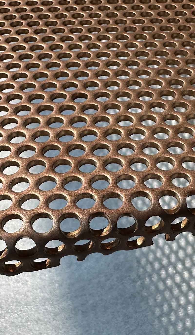 Stainless steel perforated sheet metal with embossed surface detailing