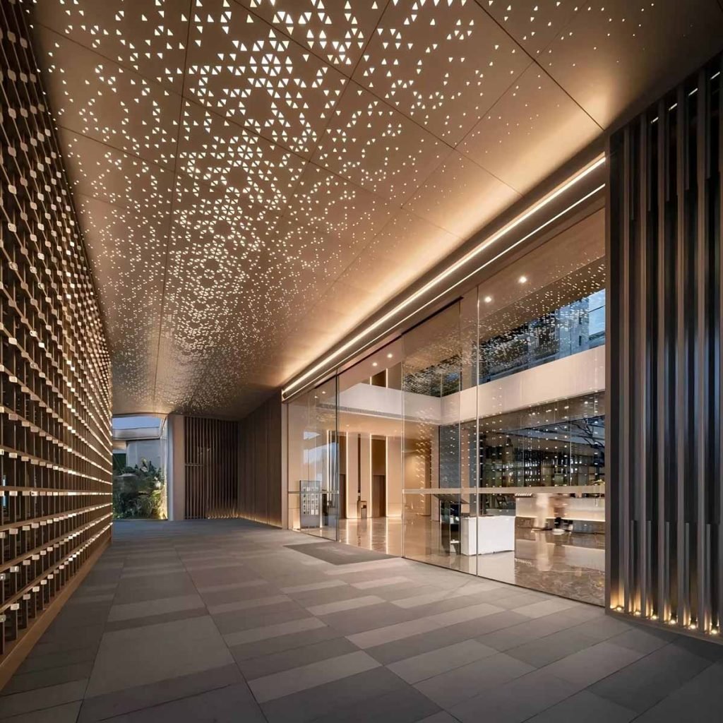 Stainless steel perforated sheets metal ceiling panels with triangular patterns in a modern commercial entrance