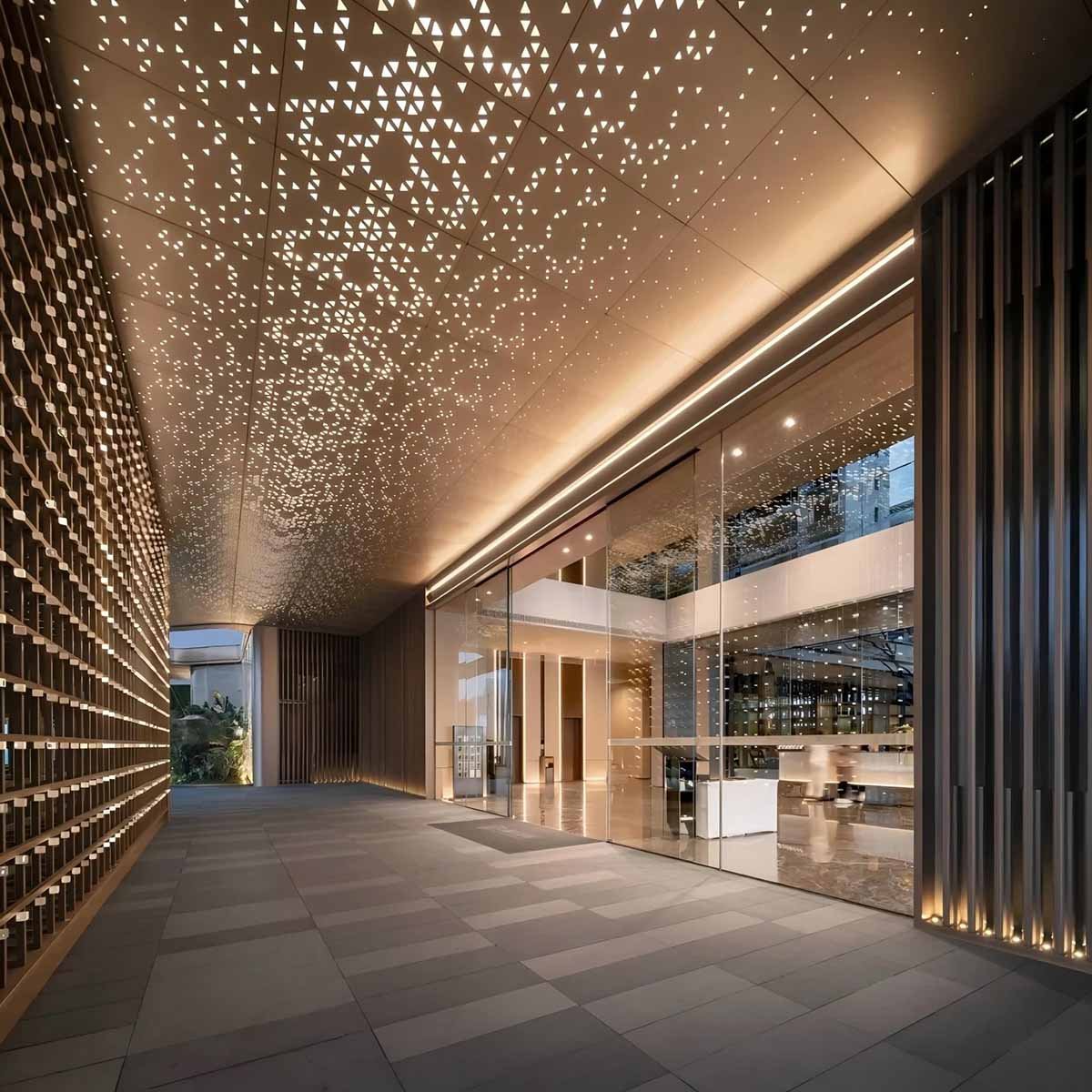 Stainless steel perforated sheets metal ceiling panels with triangular patterns in a modern commercial entrance