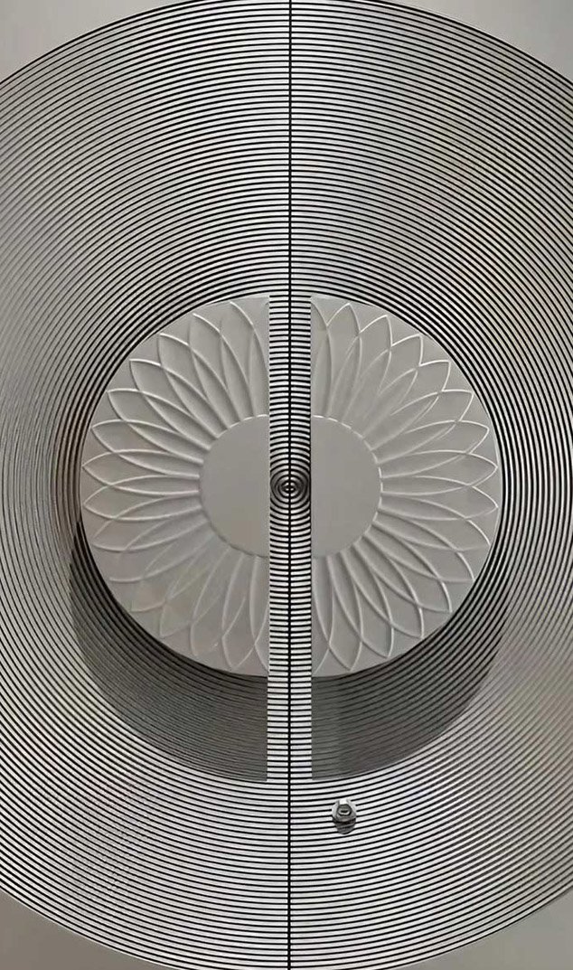 Embossed metal sheet architectural installation with patterned stainless steel surfaces