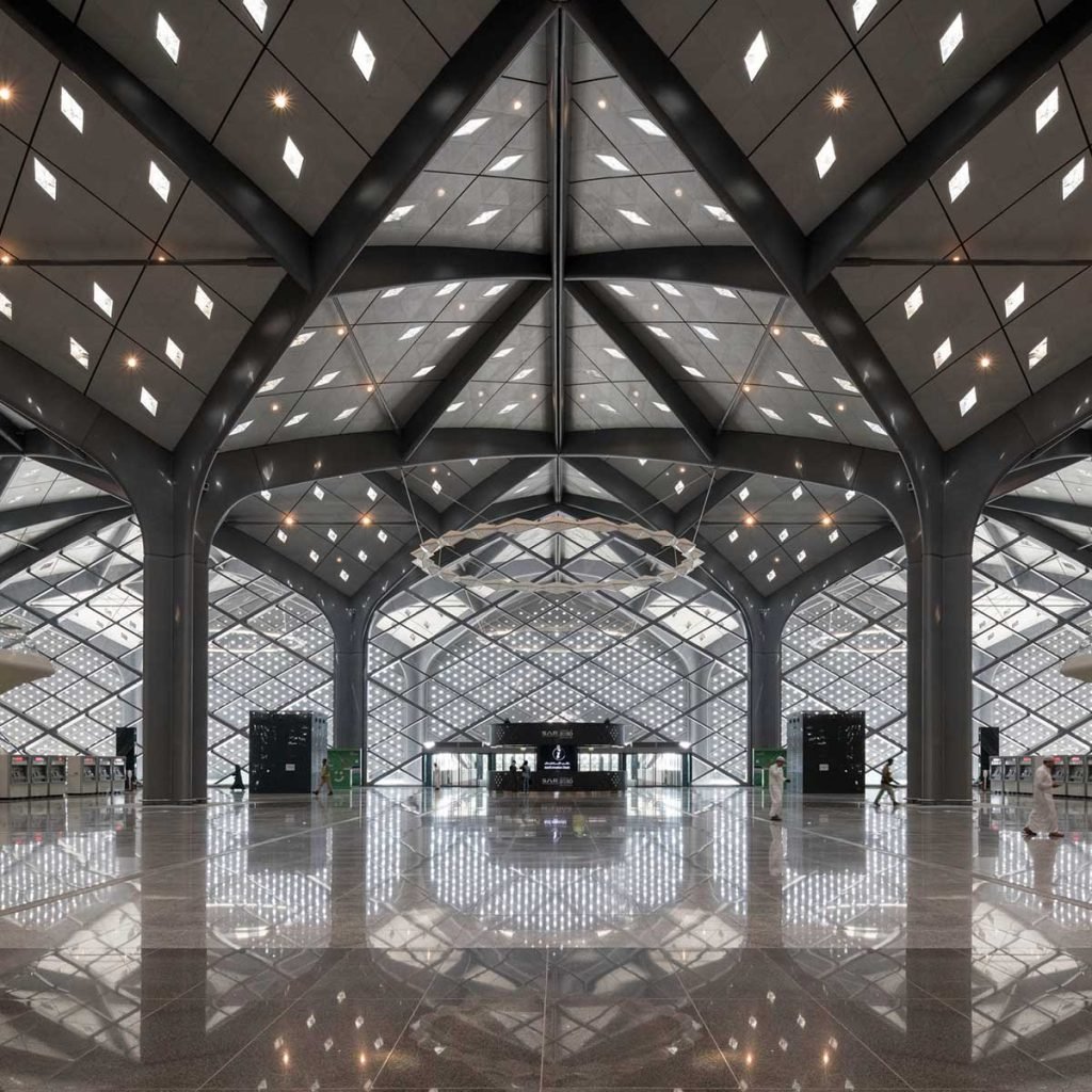 Metal roofing canopy with a sweeping architectural profile for transportation terminals