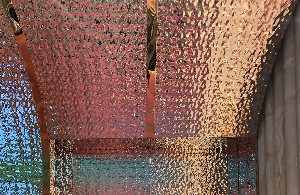 Wynn Resorts (Macau) S.A. interior featuring custom water ripple stainless steel panels