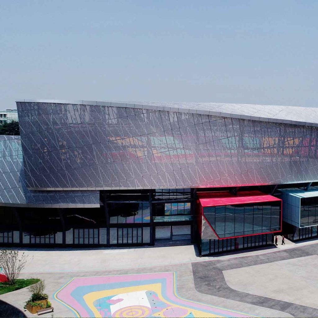 Perforated metal cladding/facade panels enhancing a modern building exterior with decorative patterns