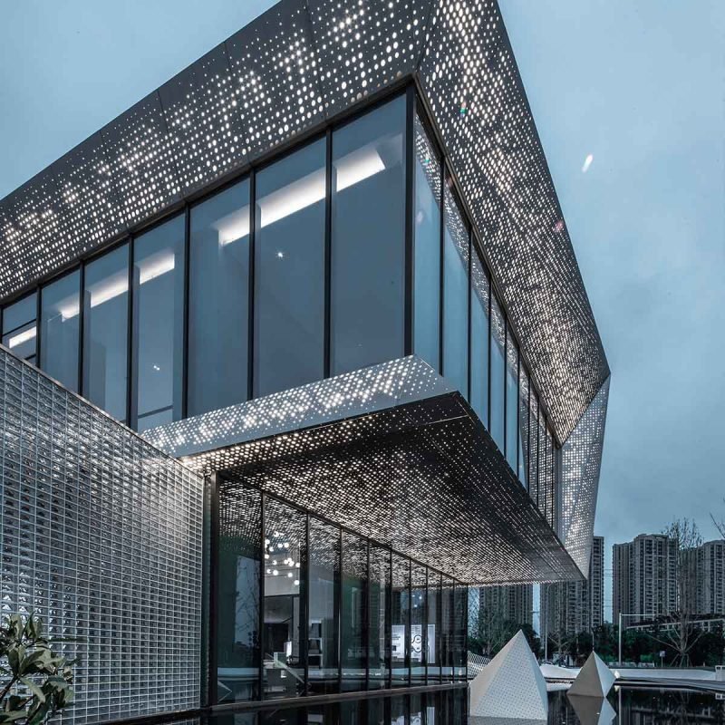 Perforated metal facade panels & cladding systems creating a modern architectural exterior with decorative patterns and durable metal cladding design