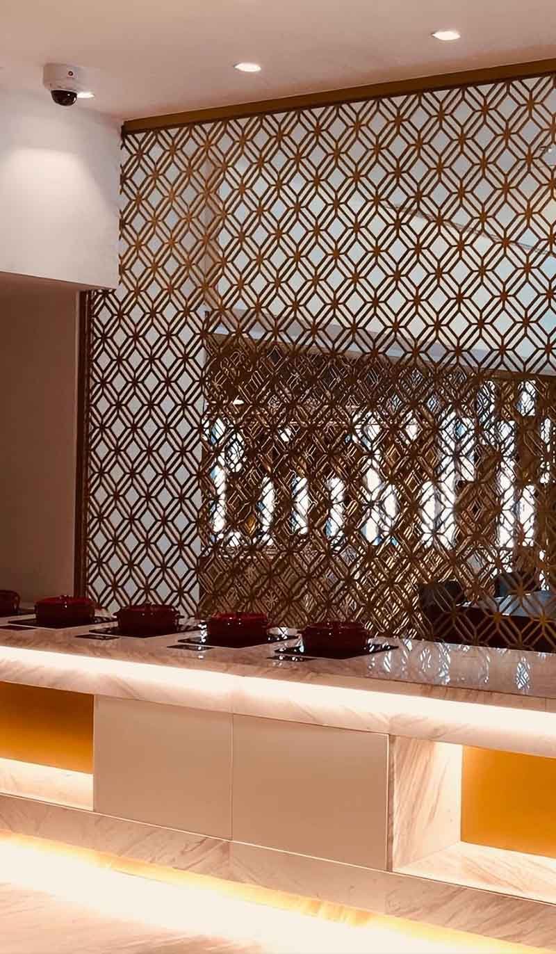 Architectural metal divider screen installed in a modern interior project with decorative partition design