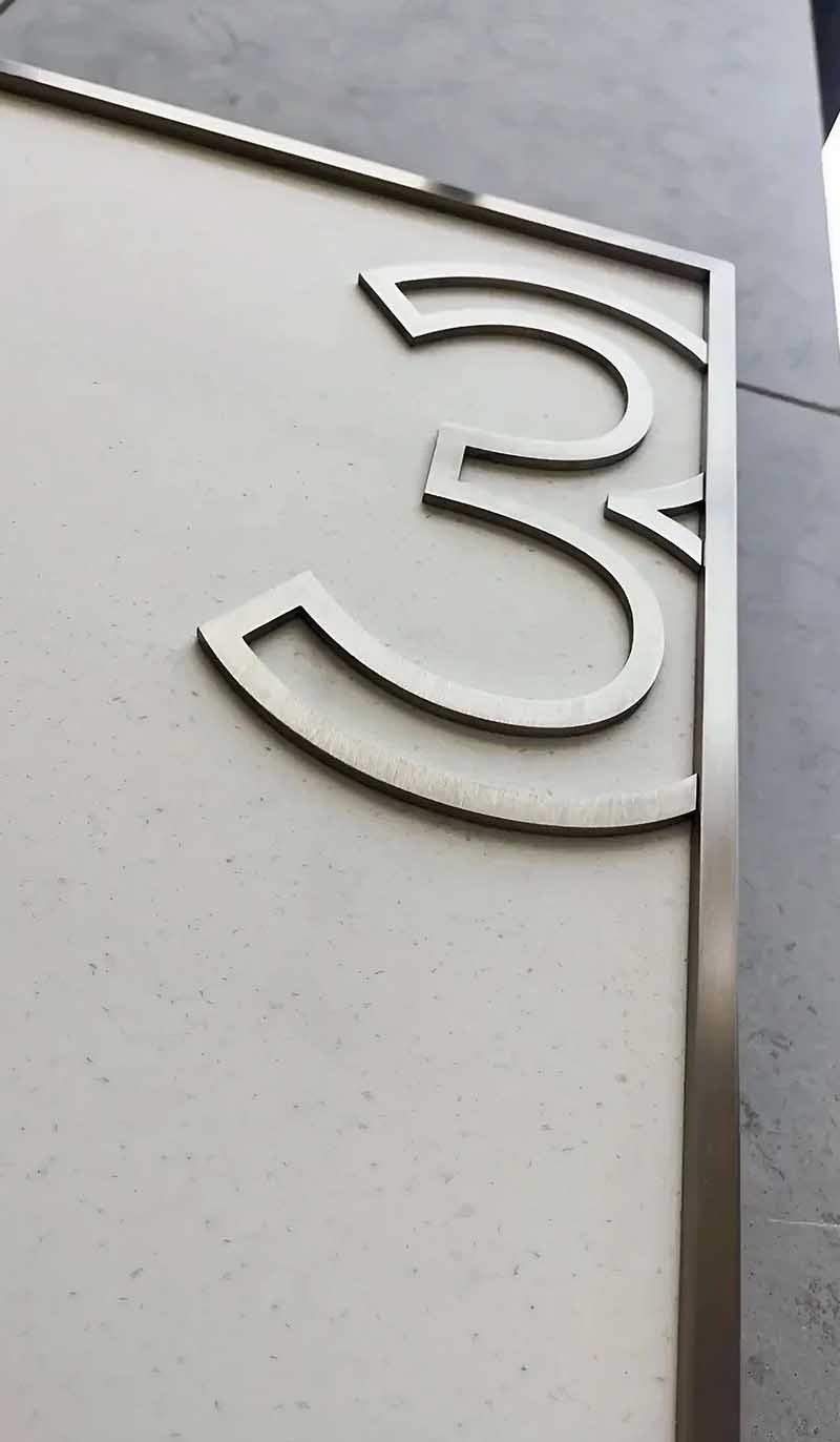 Customized stainless steel signage for architectural project identification