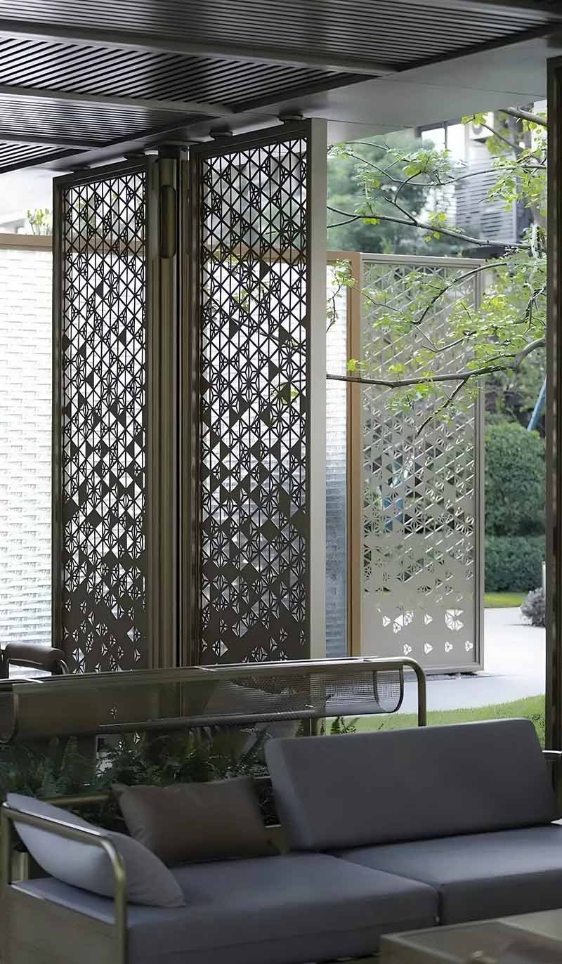 Decorative metal divider screen with laser-cut patterns for modern architectural space design