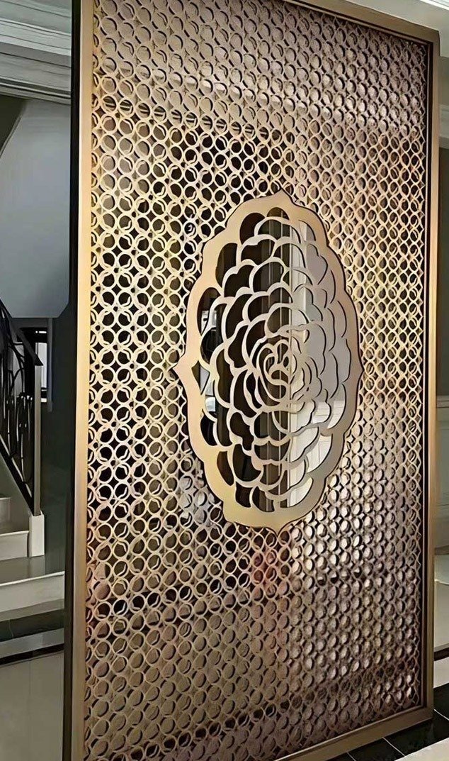 Laser cut stainless steel panels with intricate geometric perforation patterns used for architectural facade design.