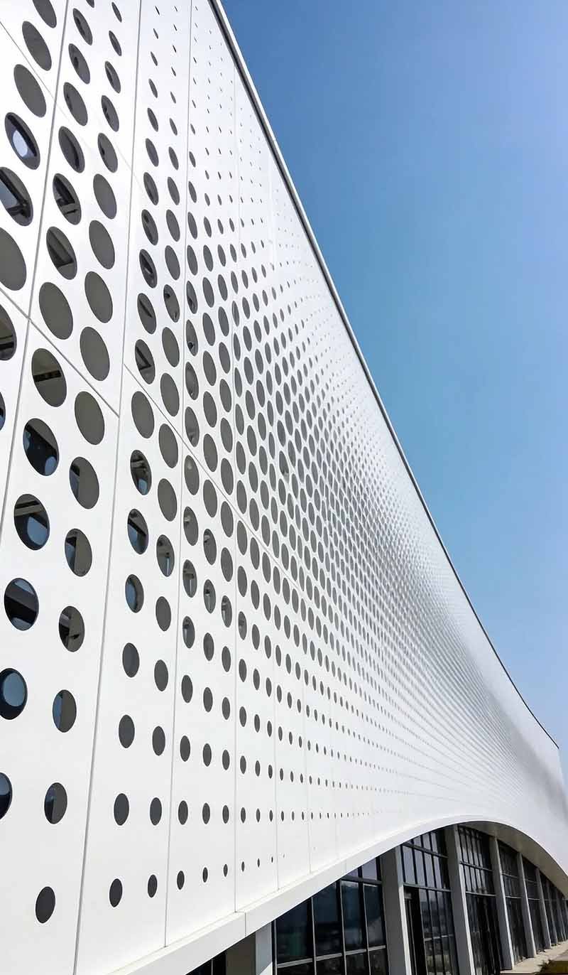 Perforated metal facade by TBK Metal Australia installed on building exterior with aluminium cladding panels