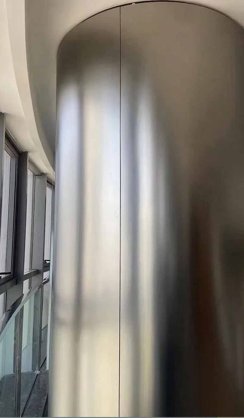 Stainless steel column wraps and covers for architectural interiors
