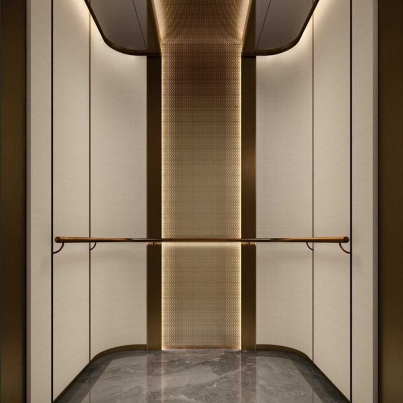 Custom stainless steel elevator wall panels with a textured center panel, bronze trim, and horizontal handrail