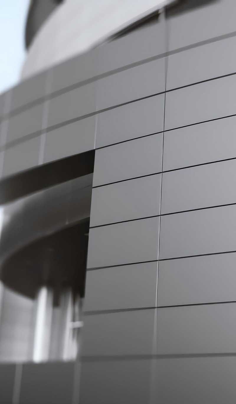 Sleek aluminium composite facade panels installed on contemporary commercial architecture