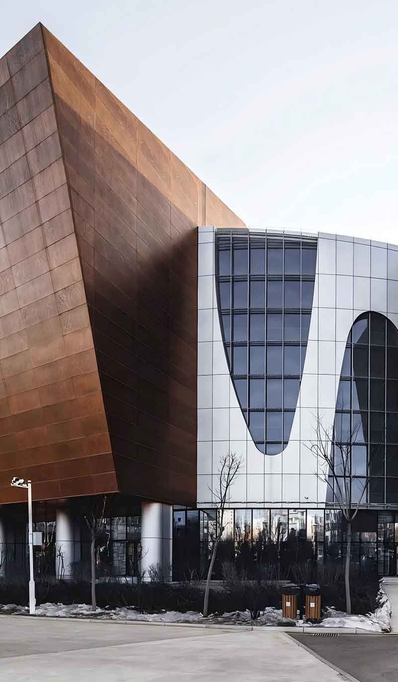 Copper cladding facade panels installed across a contemporary building with structured architectural detailing