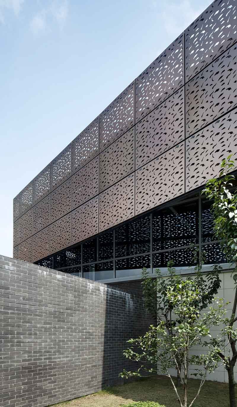 Copper facade wall cladding panels forming a detailed exterior with angled surfaces and recessed architectural elements