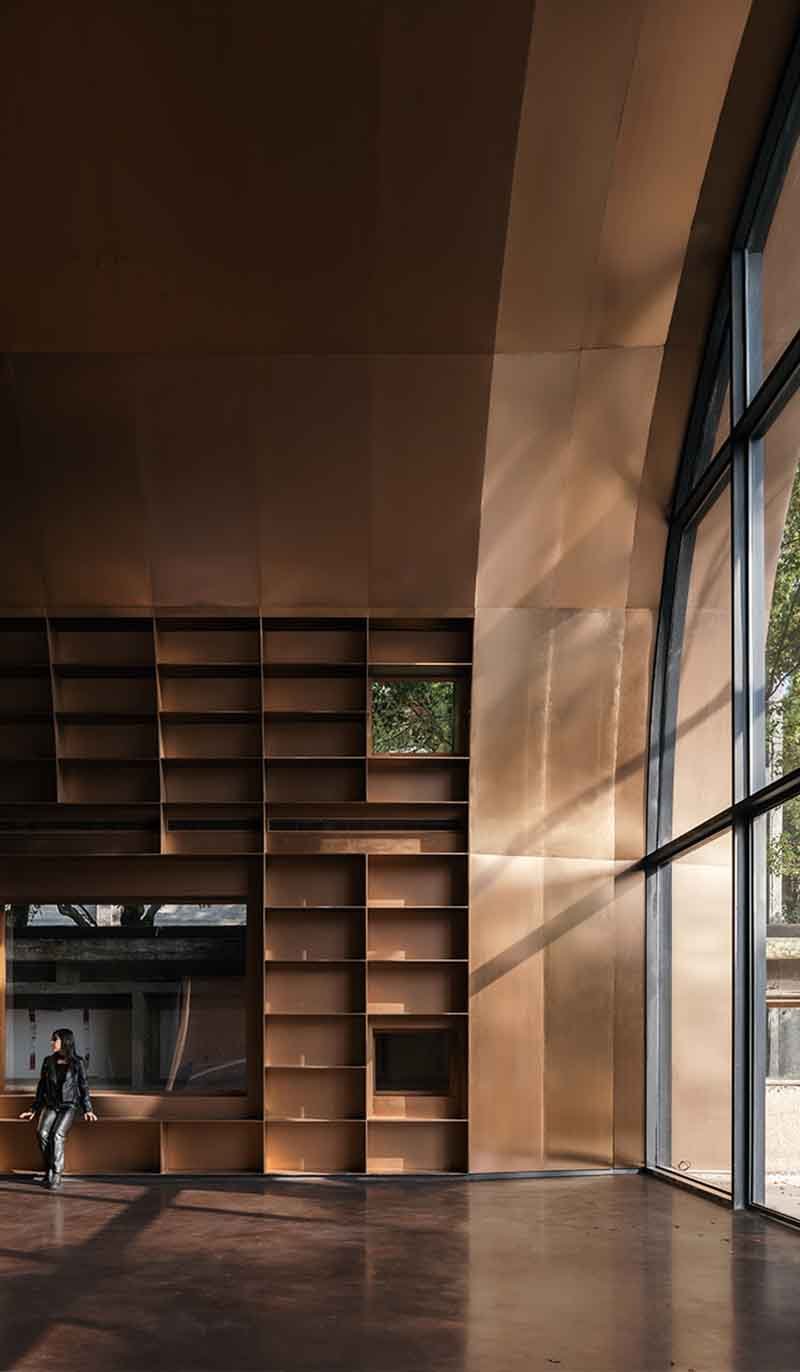 Copper wall cladding panels installed on a contemporary facade with varied surfaces and precise panel joints