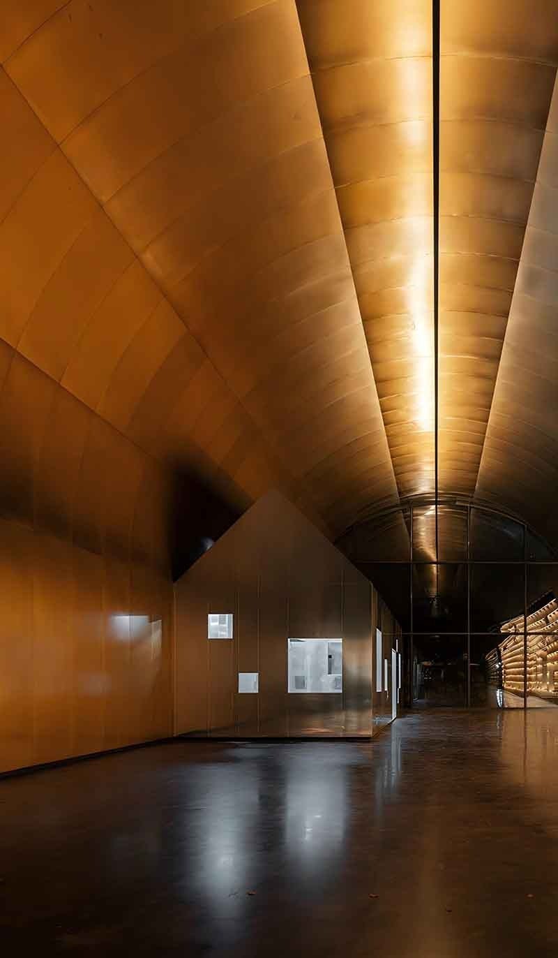 Interior copper wall panels creating a warm metallic feature wall with refined architectural detailing