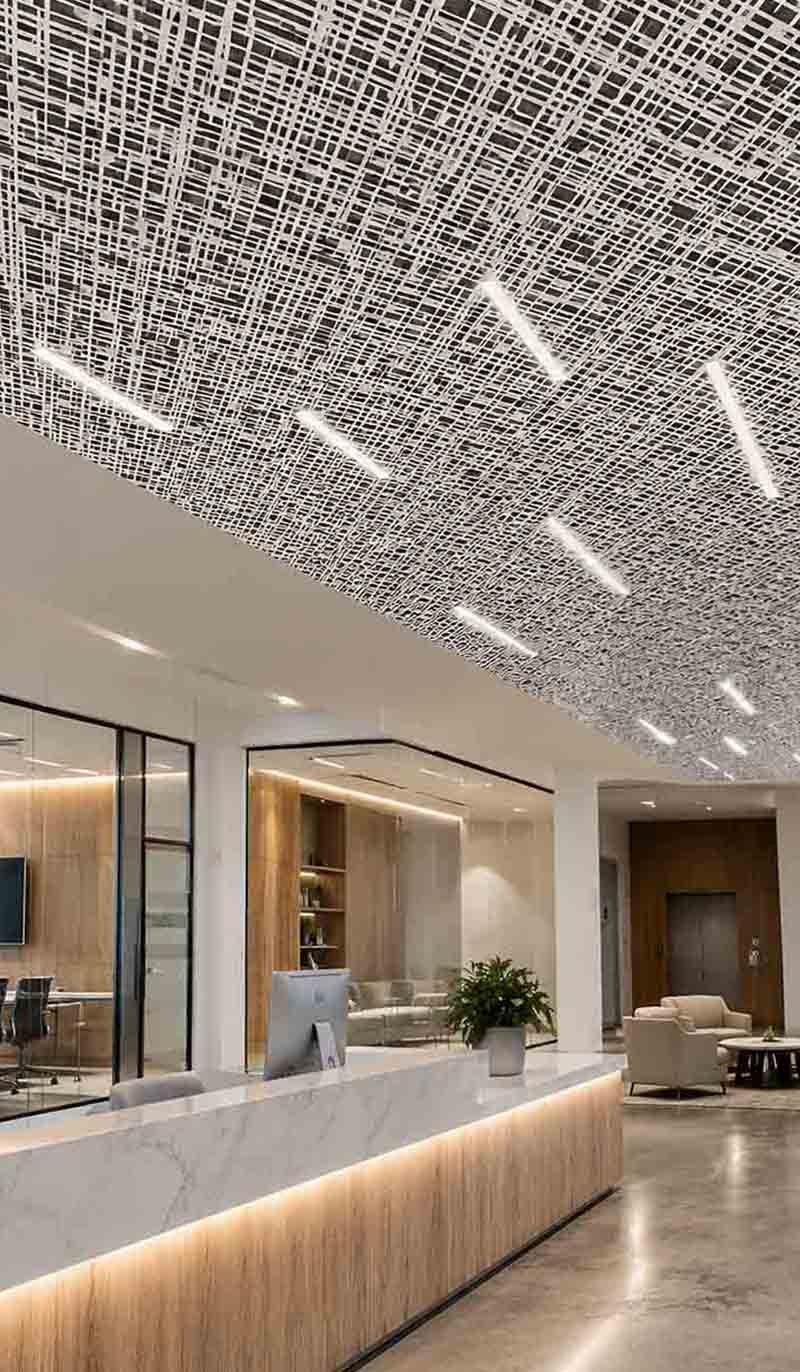 Laser-cut metal ceiling panels with precision aluminium fabrication and decorative geometric perforations in modern architectural interior