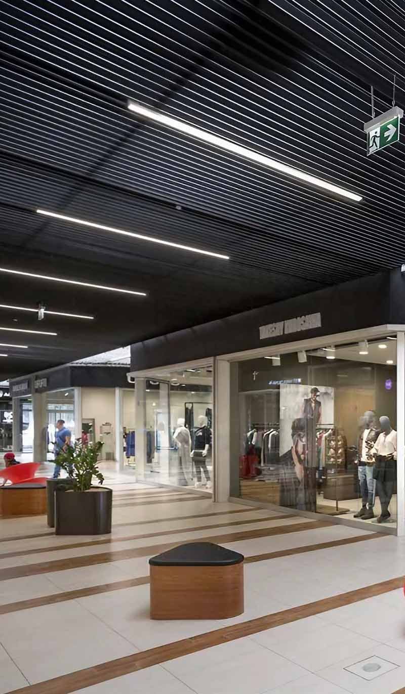 Linear metal ceiling system installed in a modern architectural interior project
