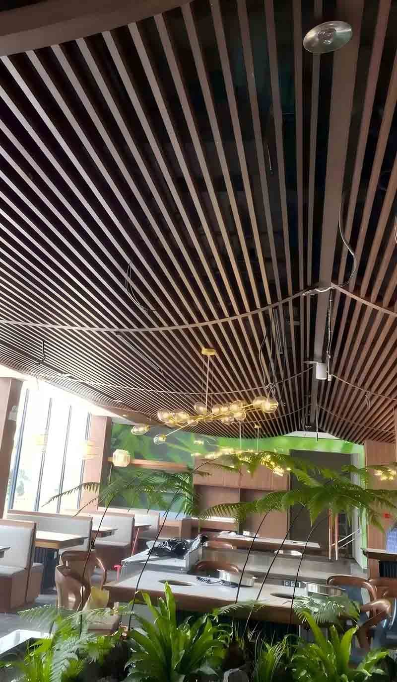 Linear metal ceiling system installed in a modern commercial interior space