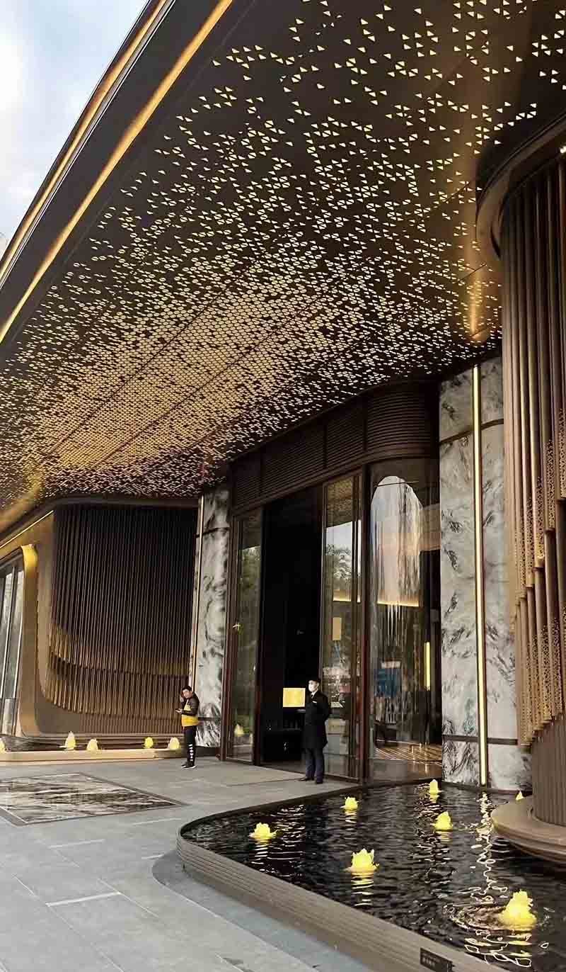 Perforated metal ceiling system applied in a modern architectural interior project