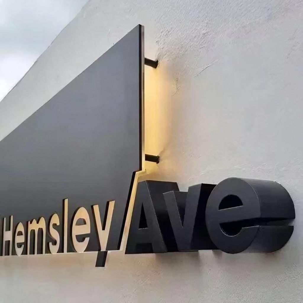Custom made stainless steel logos with brushed and polished finishes showcasing precision-cut architectural lettering for modern branding applications
