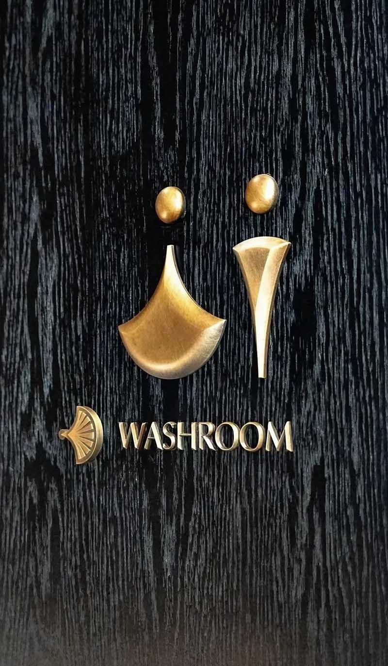 Customization options for stainless steel logos showing finish samples and design variations for architectural branding solutions