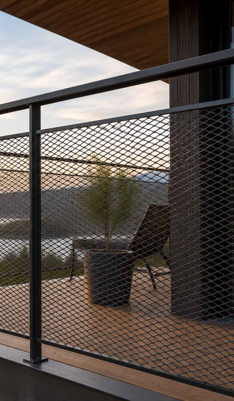Expanded metal mesh guardrails and railing panels in an architectural project