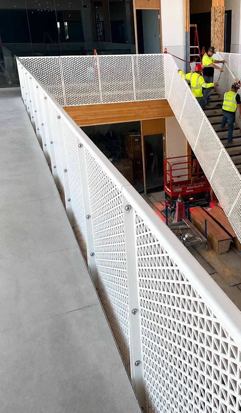 Custom perforated metal railing panels for a contemporary architectural project