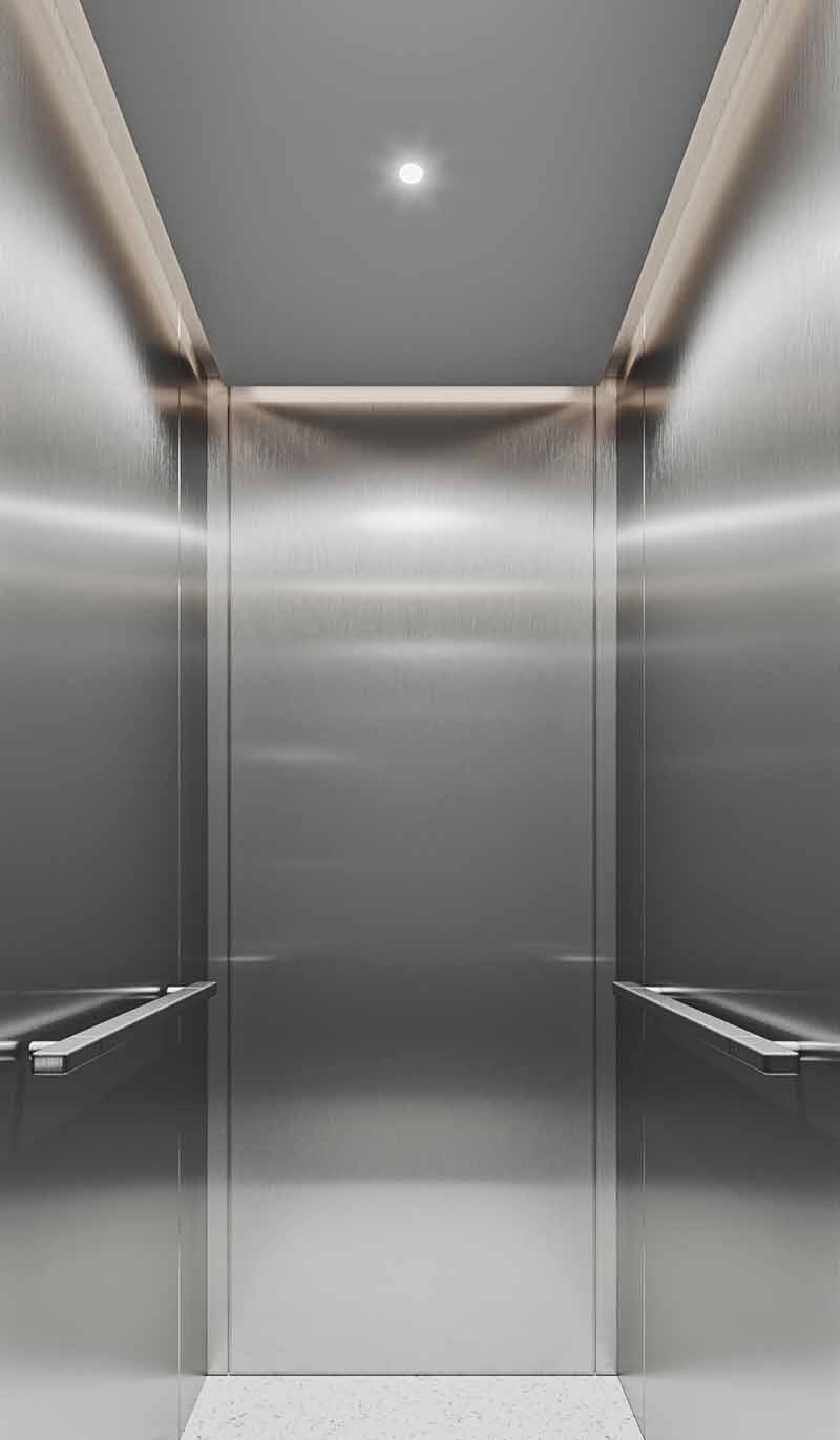Custom stainless steel ceiling panels fitted inside an elevator cabin