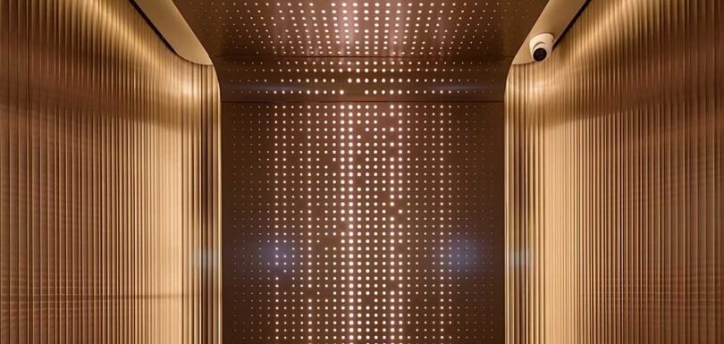Stainless steel elevator cabin design featuring elegant metal finishes and modern interior details