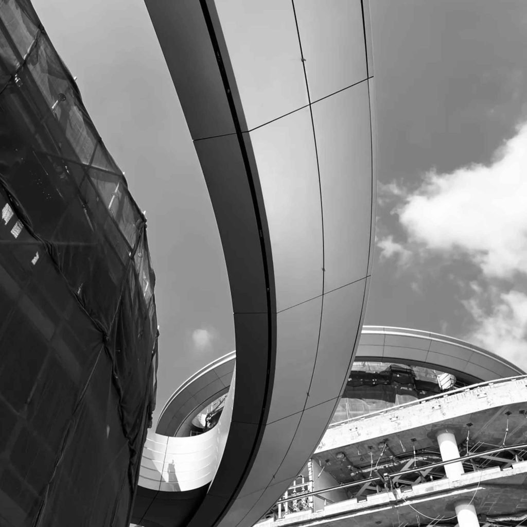 Double-curved aluminium cladding systems integrated into a flowing contemporary building exterior