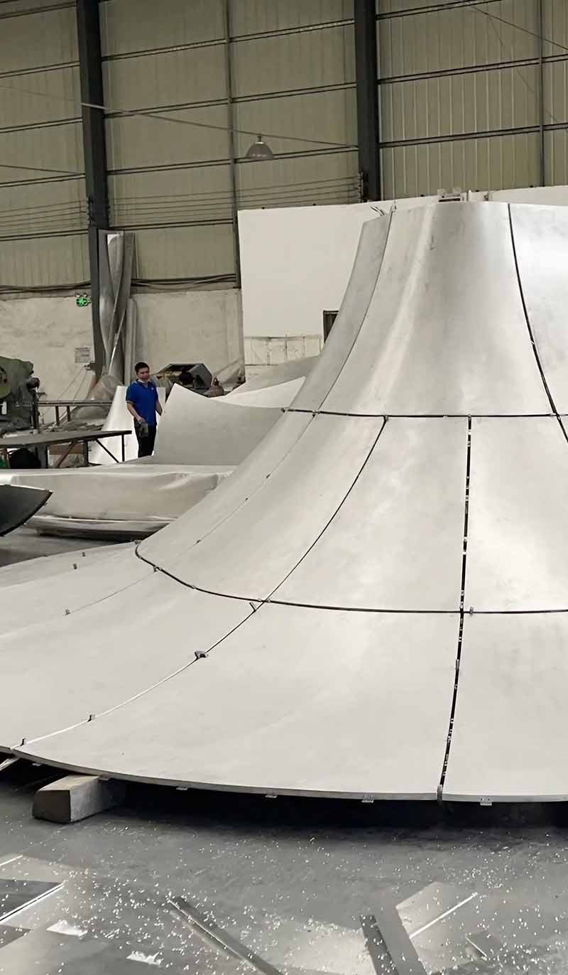 Custom double-curved aluminium facade panels shaped for varied architectural wall designs