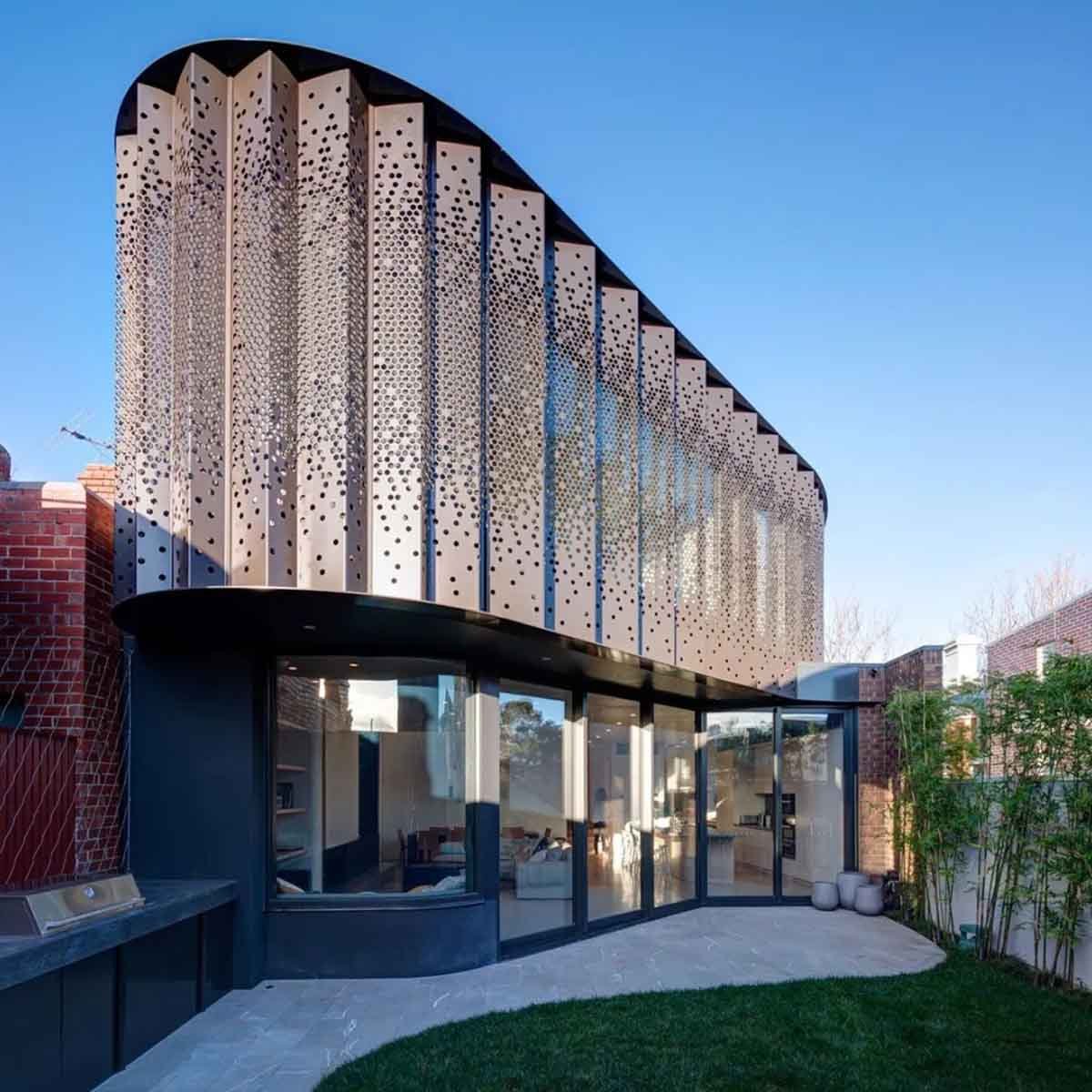 A modern building facade featuring various materials, textures, and design approaches.